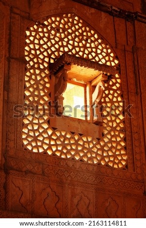 Royalty free photo of a Carved Stone window in a tomb of muslim ruler of Sindh Miza Isa Khan Tarkhan II (1644 AD), at Makli necropolises. One of the largest necropolises in the world.