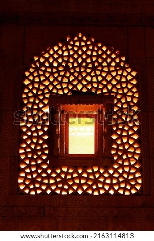 Royalty free photo of a Carved Stone window in a tomb of muslim ruler of Sindh Miza Isa Khan Tarkhan II (1644 AD), at Makli necropolises. One of the largest necropolises in the world 
