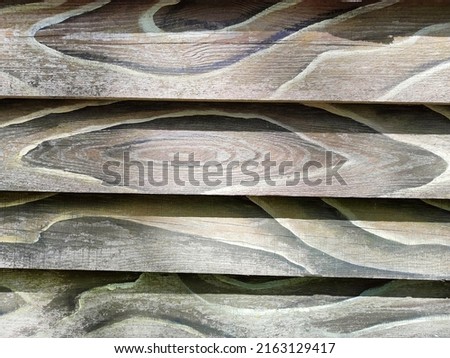 The texture of wood, the wall of the boards. Wood cuts are visible on the boards.