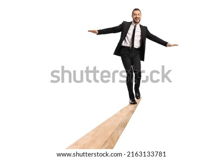 Full length portrait of a businessman walking on a wooden beam isolated on white background