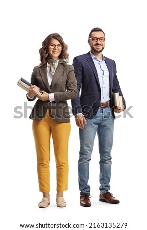 Full length portrait of a young man and woman standing and holding books isolated on white background Royalty-Free Stock Photo #2163135279