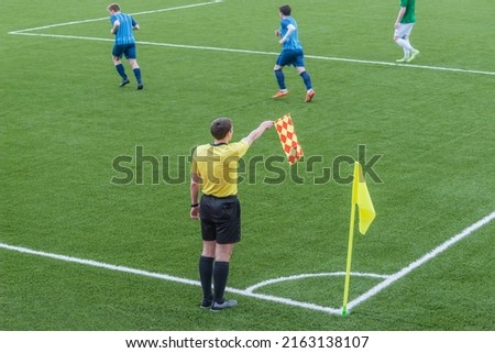 Referee from the sidelines of a soccer game. Royalty-Free Stock Photo #2163138107