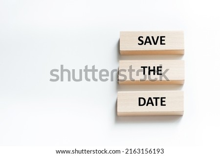 Save the Date word written on wood block. Save the Date text on table, concept