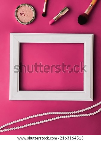 White horizontal art frame, make-up products and pearl jewellery on pink background as flatlay design, artwork print or photo album concept
