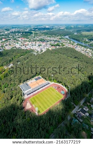 Alytus city stadium stands in between pines in the city center 