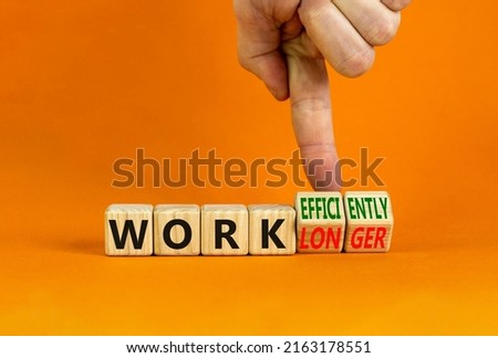 Work longer or efficiently symbol. Businessman turns cubes and changes words work longer to work efficiently. Beautiful orange background, copy space. Business and work longer or efficiently concept.