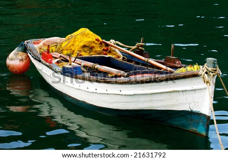 Colorful picture of a moored fishing boat full of fishing accessories
