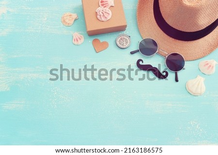 Father's day and travel concept over blue wooden background. top view, flat lay