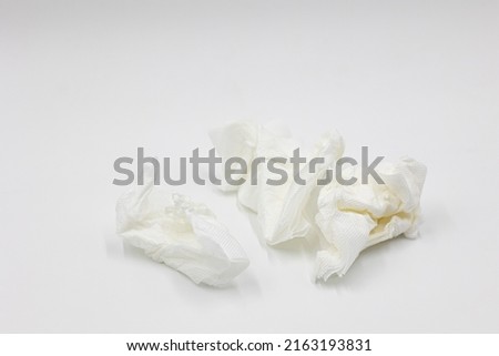 Several crumpled white used white paper napkins isolated on a white background