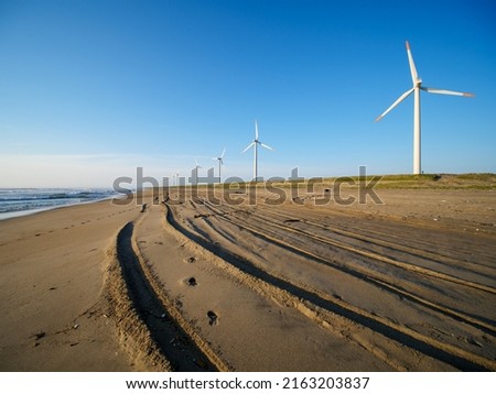 Clear blue sky and wind turbines on the beach. Scenery of Hasaki Coast, Kamisu City, Ibaraki Prefecture, Japan.