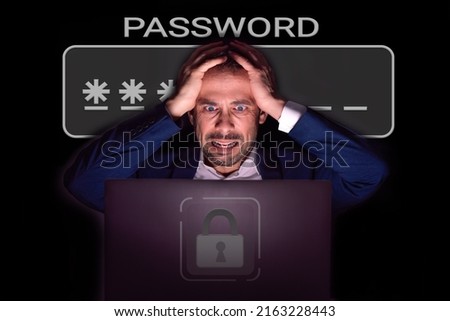 Man in the dark with his hands on his head who has forgotten a password Royalty-Free Stock Photo #2163228443
