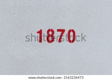 Red Number 1870 on the white wall. Spray paint.

