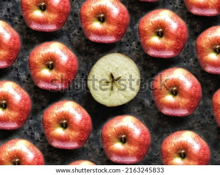 Pattern of red apples and slice of apple with star on black concrete background. Creative flatlay with summer fruit.