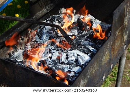 Fire and coals in the barbecue grill. High quality photo