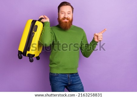 Photo of positive young man promote a vacation tour weekend holidays trip isolated on purple color background