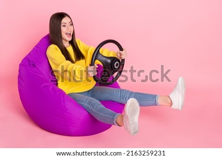 Full size profile side photo of young excited girl drive automobile fast look empty space isolated over pink color background