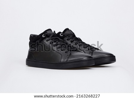 Black fashionable business men's leather slip-on shoes sneakers for male isolated on white background. Blank sport casual basic shoes. Mock up, template Royalty-Free Stock Photo #2163268227