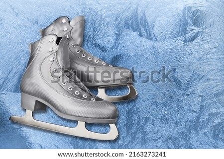 Classic Ice skates on blue ice background