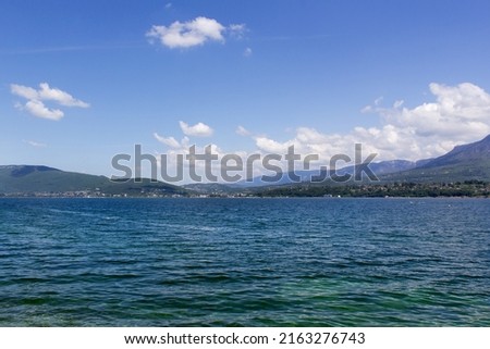 Beautiful panorama mountain water lake view from beach with blue sky