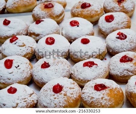 Hanukkah donuts with jam in bakery.