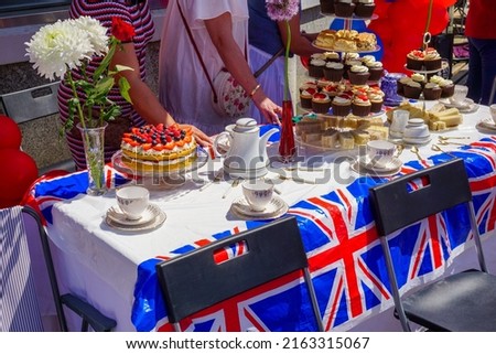 British street party with English tea and cakes. table of tasty snacks at local street party celebration.  Royalty-Free Stock Photo #2163315067