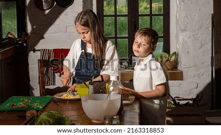 boy and girl cooking in the kitchen, real photo