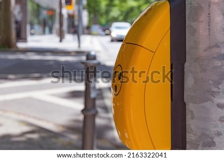 a pedestrian traffic light with push button for blind people in selective focus