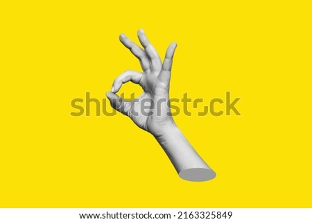 The female hand showing the ok gesture isolated on a yellow color background. Trendy abstact 3d collage in magazine urban style. Contemporary art. Modern design. Okay hand sign Royalty-Free Stock Photo #2163325849