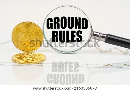 Business and technology concept. There are bitcoins on the chart and there is a magnifying glass with the inscription - GROUND RULES