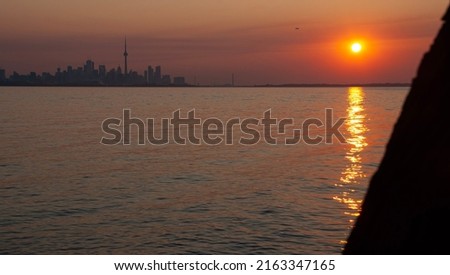 The sun rises over Lake Ontario, Canada