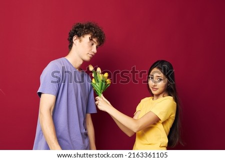 young boy and girl a bouquet of yellow flowers based friendship red background unaltered
