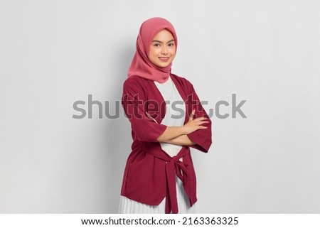 Smiling beautiful Asian woman in casual shirt crossed arms and looking confident isolated over white background