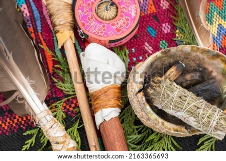 A bundle of sage and an eagle feather are laid out in preparation of a Native American, Indian, or Indigenous smudging ceremony.  Pemberton BC, Canada. 

