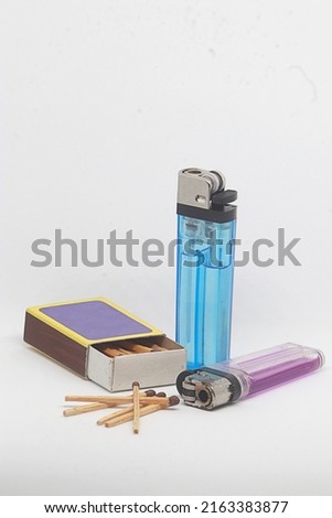 the set of lighters consists of two gas lighters and a wooden matchbox Royalty-Free Stock Photo #2163383877