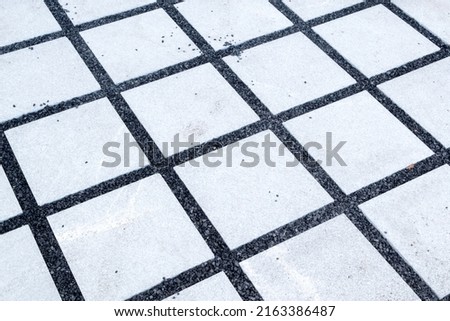Figure out the paving slabs in the square. Background of paving slabs. Texture of stone products.