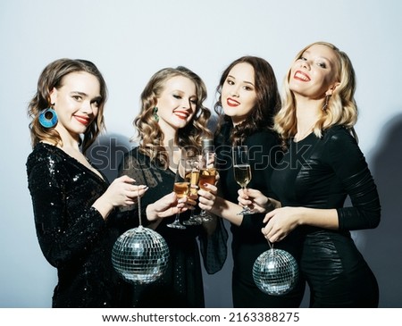 Four Party women in black dress with disco balls and wine
