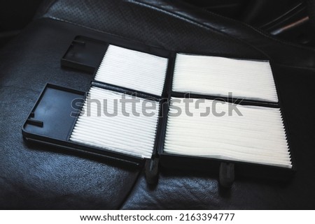 New car air filter on a leather black car seat