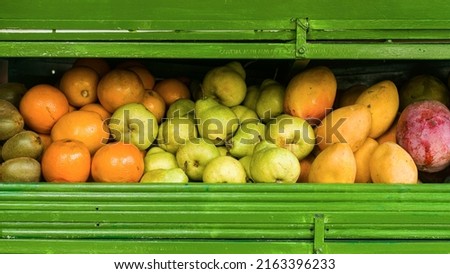 Oranges, pears and mangos in fruit stand