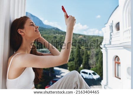 Portrait woman with long hair on an open balcony Green nature summer day Perfect sunny morning