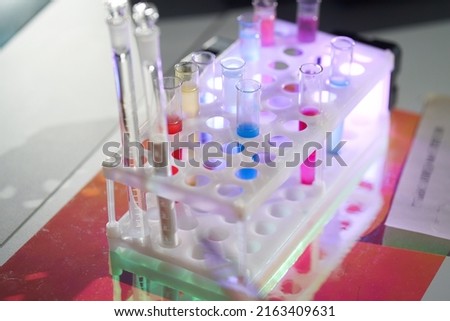 A set of laboratory utensils for medical or scientific research. A beaker with chemicals. Laboratory glass equipment, test tubes and flasks. High quality photo