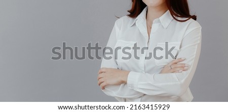 Business woman with crossed arms in a white shirt. Confident successful girl. High quality photo