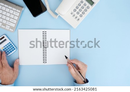 Man hand holds a pen and signs a contract agreement on paper. Business, lawyer, finance, notary, trading, loan, and accounting concepts