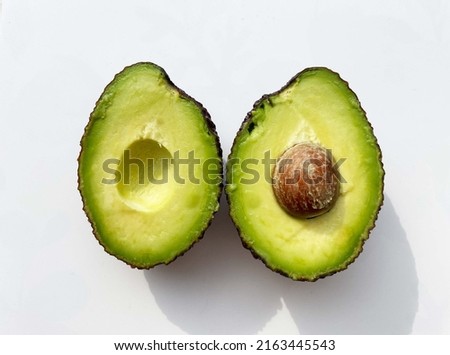 two halves of a ripe avocado