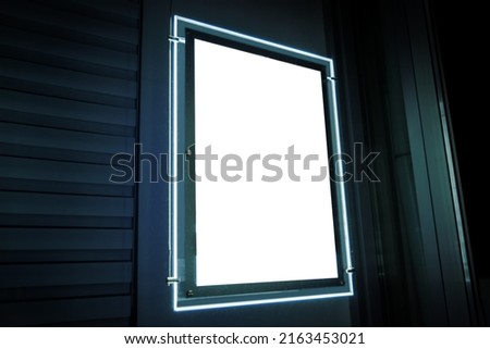 modern lighting signage frame in window street shop night blank mockup template blurred soft focus