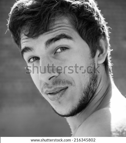 Portrait of a young handsome male athlete who is looking at the camera