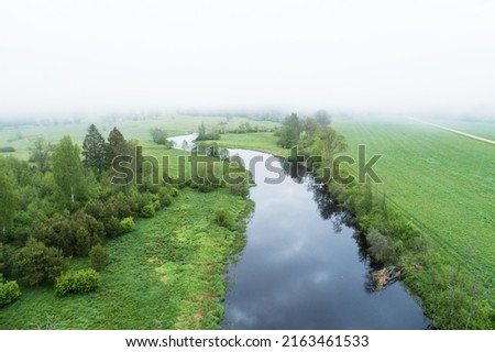 High angle view to a misty river landscape on a late spring morning in Estonia, Northern Europe Royalty-Free Stock Photo #2163461533