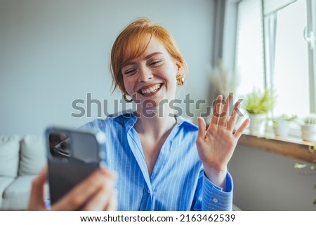 Happy beautiful gen z teen girl blogger smiling face waving hand talking to webcam recording vlog, social media influencer streaming, making video call at home. 

