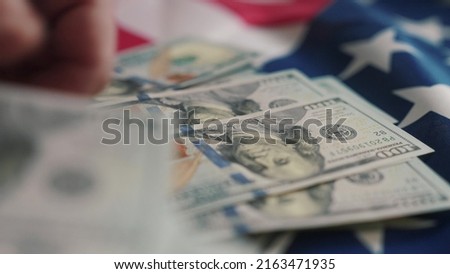 dollar money and American flag. bankrupt usd man counting money cash. business crisis finance dollar concept. close-up of a hand counting paper dollars. exchange finance economy dollar pay tax
