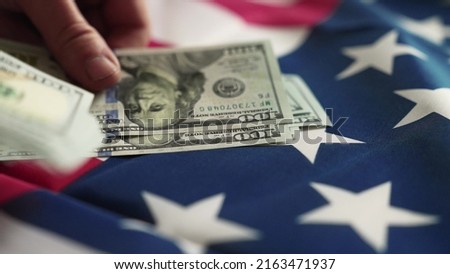 dollar money and American flag. bankrupt man counting money cash. business crisis finance usd dollar concept. close-up of a hand counting paper dollars. exchange finance economy dollar pay tax