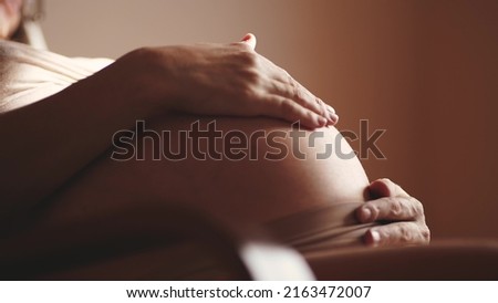 pregnant woman. health pregnancy motherhood procreation concept. close-up belly of a pregnant woman. woman waiting for a newborn baby. sunlight pregnant woman holding her belly indoors Royalty-Free Stock Photo #2163472007